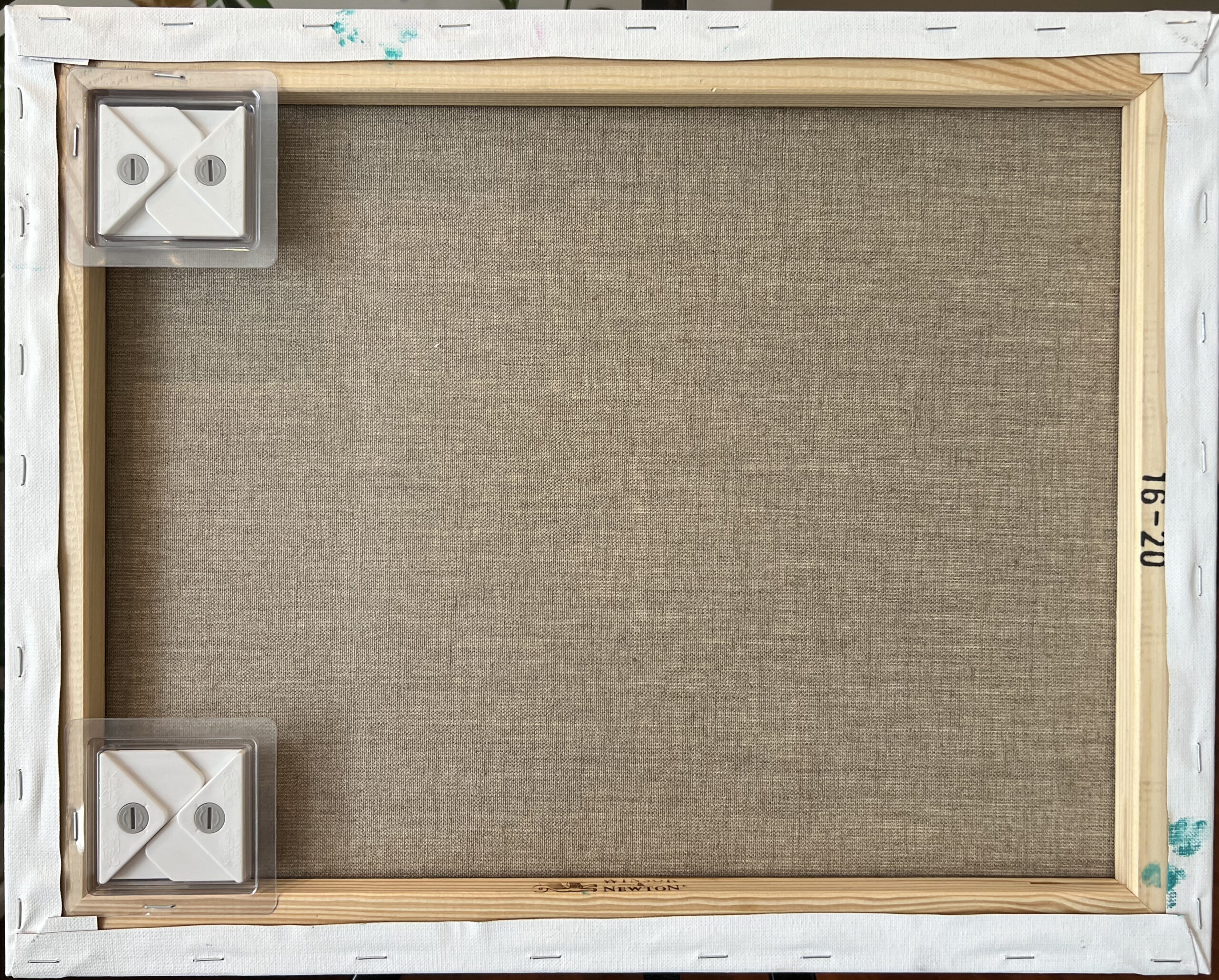 Back of the Black Triangle canvas on a wooden stretcher frame with two hanging hooks