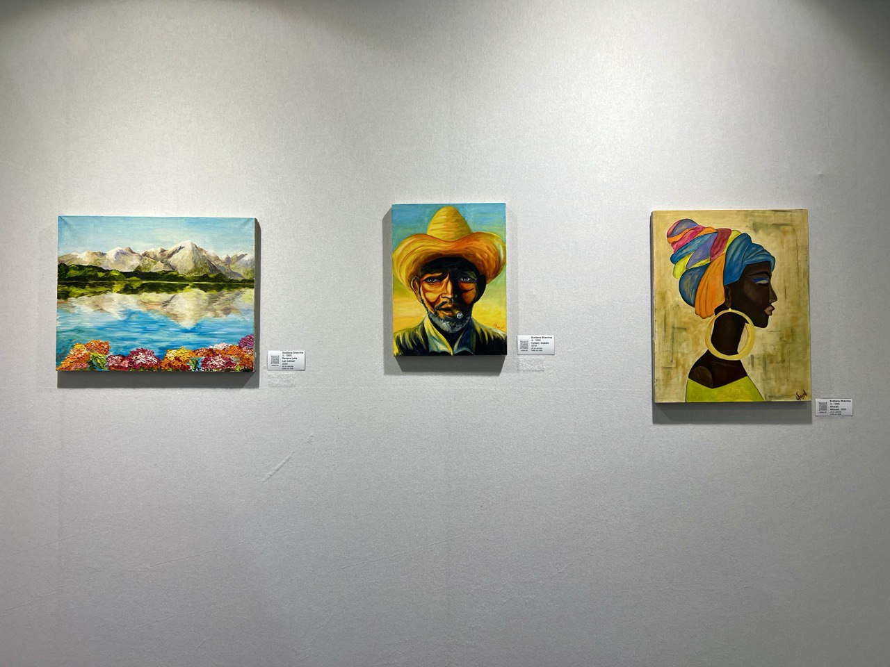 Cuban and other oil paintings by Lana Swan on an exhibition wall