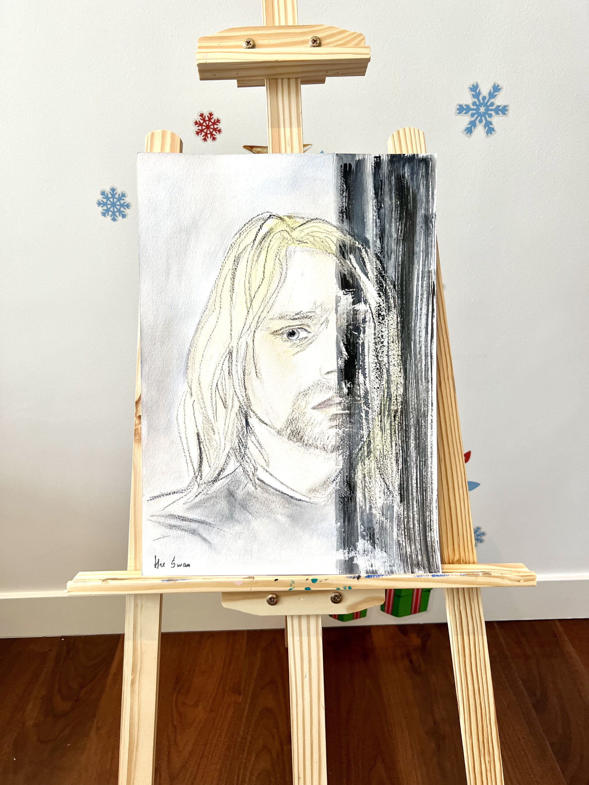 Kurt Cobain portrait by Lana Swan shown on a wooden easel