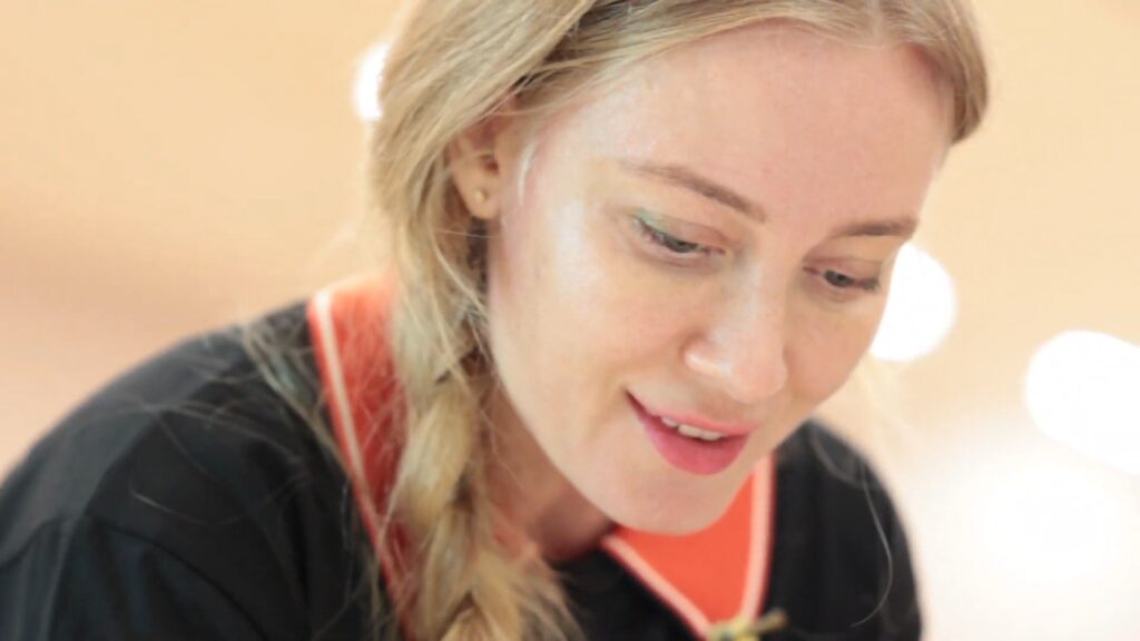 Close-up of Lana Swan smiling as she paints during Atelier Little Picasso in Abu Dhabi