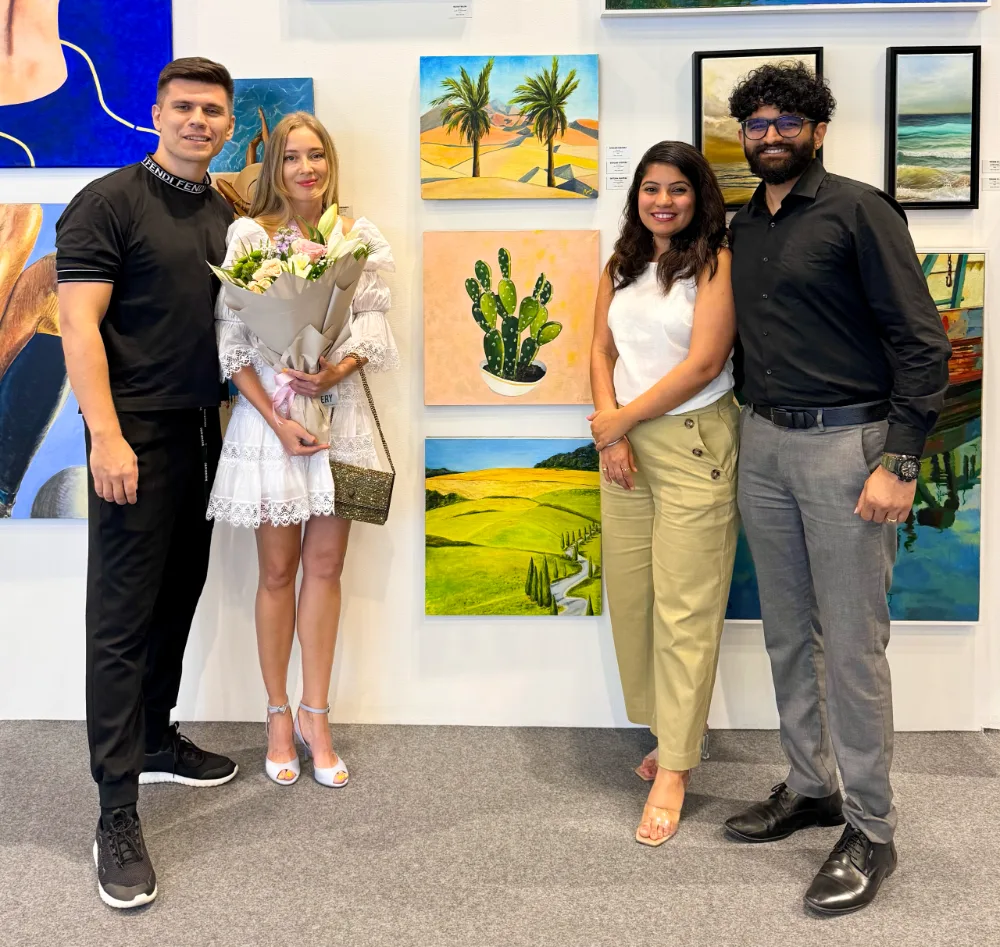 Lana Swan with guests in front of her paintings at World Art Dubai 2024